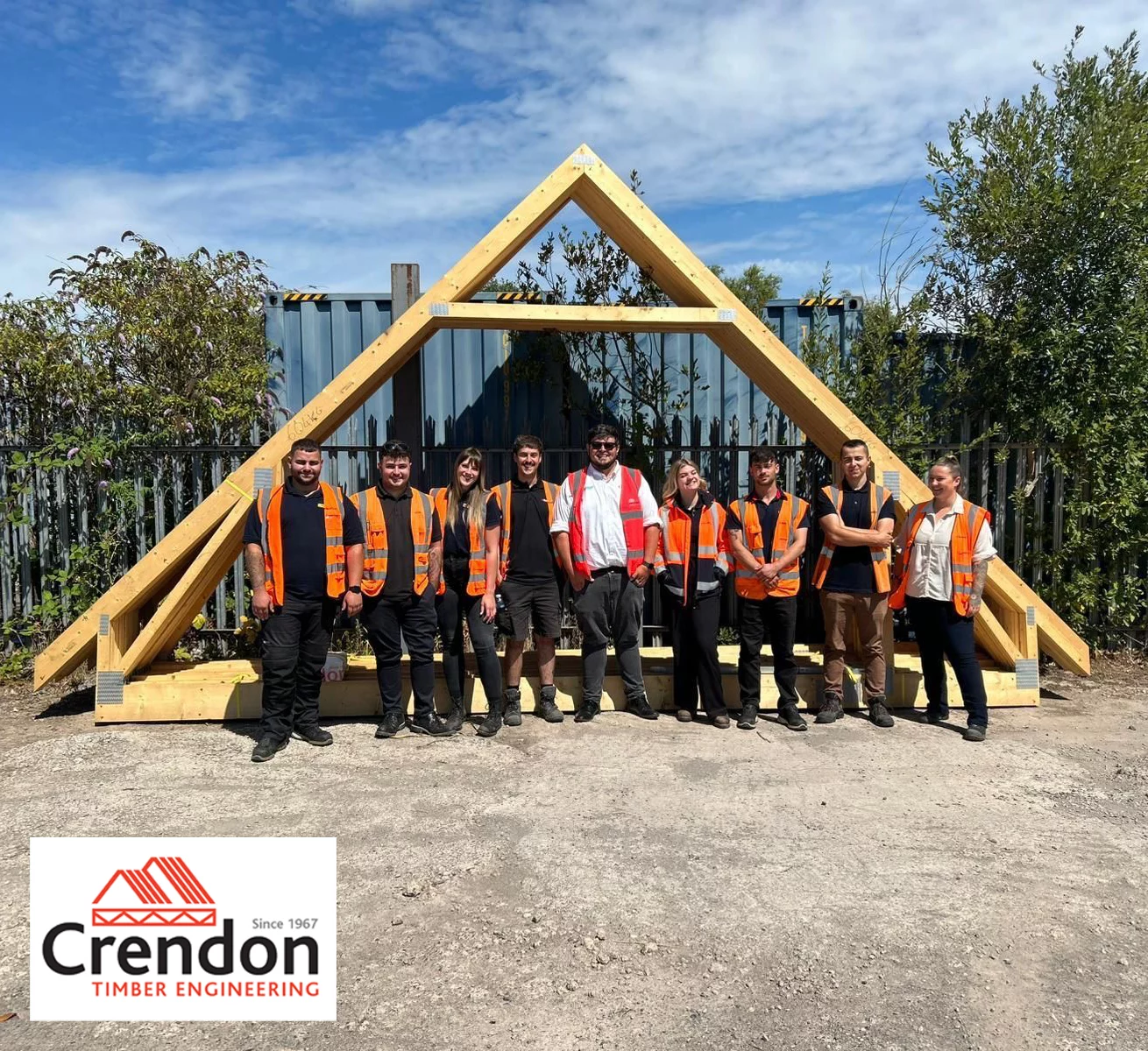 Group of people stood in front of a roof truss