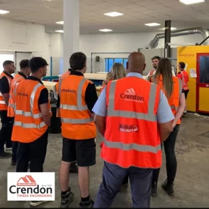 Group of people listing to a talk in a factory