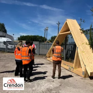 Group of people stood near a roof truss